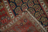 Detail of the antique Persian runner's hand-knotted foundation, secure selvage, and fringe.