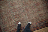 Antique Senneh rug, intricate ivory and terra cotta paisley field, blue Herati border, visible wear.
