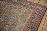 Antique Senneh rug detail: intricate ivory paisley field, terra cotta and blue Herati border.