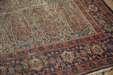 Antique Senneh rug: worn ivory field, intricate paisley botehs, cobalt blue Herati border.