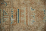 Low hand-knotted pile of an antique Art Deco carpet with geometric and scrolling blue motifs.