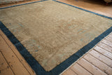 Perspective view of a hand-knotted Art Deco carpet, highlighting its low pile and sand-colored ground.