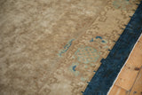 Geometric scrolling border detail with cobalt and powder blue on a beige antique carpet.