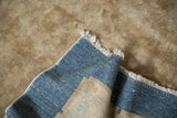 The blue hand-knotted foundation and secured side selvage of an antique Chinese Art Deco rug.