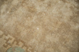 A minor white knot surfaced on the sand-colored, hand-knotted pile.