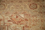 Worn hand-knotted texture showing the foundation and geometric floral border of a distressed Heriz rug.