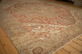 Distressed texture on the floral and serrated leaf border of a vintage Heriz carpet.