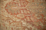 Worn pile of a vintage Heriz carpet reveals the hand-knotted texture in terra cotta, sage, and platinum hues.