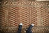 Overhead view of a distressed Hamadan runner highlighting the even wear across its lattice boteh pattern.