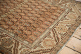 Corner detail of a vintage Hamadan rug with a boteh lattice field and a bold serrated leaf border.