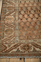 Serrated leaf border and boteh field patterns on a distressed vintage Hamadan rug runner.