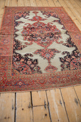 Antique Fereghan rug showing ivory field, tomato red corner spandrel, and navy finial detail.
