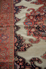 Intricate red and navy spandrel adjoining the geometric border of an antique Fereghan rug.