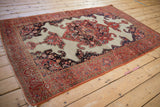 Antique Fereghan rug corner: intricate red border, ivory ground, navy corner spandrel, and intact selvage.