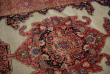 Patinaed ivory ground, tomato red medallion finials, and navy blue floral motifs.