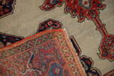 Folded corner of an antique Fereghan rug, showing intricate hand-knotted foundation and red selvedge.