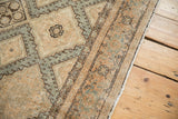 Intact side cord selvage alongside hook-and-latch motifs on an abrashed vintage Sivas carpet.