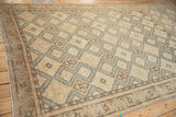 Repeating diamond medallions with hook-and-latch details on a distressed vintage Sivas carpet.