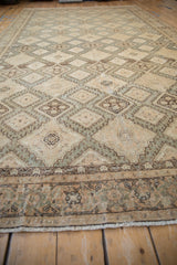 Low-angle view of a vintage Sivas carpet showing the repeating diamond pattern and detailed border.
