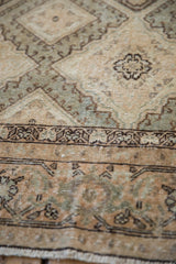 Detailed hook-and-latch perimeter outlines on the worn, abrashed field of a Sivas rug.