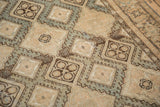 Angled detail of hooked diamond medallions on an abrashed, distressed vintage Sivas rug.