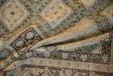 The supple weave and time-softened texture of a distressed Sivas carpet in a draped view.