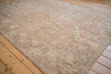 Wide angle view of a distressed Sultanabad carpet, highlighting its soft patina and botanical designs.