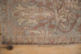 The worn knot heads and side cord of a distressed Sultanabad carpet.