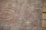 Worn pile showing time-softened floral and vinery borders on an antique Sultanabad carpet.