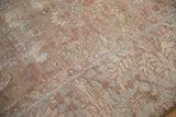 Close-up of the distressed, hand-knotted pile on an antique Sultanabad carpet in muted tones.