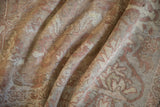 Soft folds showing the time-worn texture and low, hand-knotted pile of an antique Sultanabad.