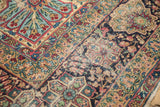 Antique Kerman carpet detail, blossomed floral bouquets, meandering vines, cochineal red, and wear.