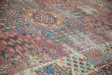 Worn antique Kerman carpet detail with thousand flower motif in cochineal red and sky blue.