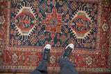 Antique Karaja rug's central geometric medallion in cherry red and cobalt blue, with a detailed surrounding field.