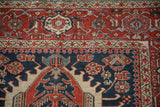 Close-up of the antique Karaja rug's geometric pawn overlay and floral guard border.