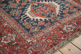 Reciprocating pawn overlay border against the cobalt blue field of an antique Karaja rug.