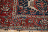 Corner view of a fine Karaja rug with a red pawn overlay border next to a cobalt blue floral field.