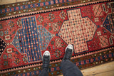 Close view of a Persian Baktiari runner's seed design within sky blue and dusty rose medallions.
