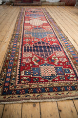 The long perspective of a vintage Baktiari runner highlights its repeating column of geometric medallions.