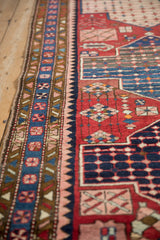 Side border of a Persian Baktiari runner showing floral bouquets and the hand-knotted side cord edge.