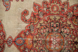 Scrolled and serrated contour of a corner spandrel on a fine antique Persian Malayer rug.