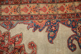Close-up showing the serrated corner spandrel and floral border of an antique Persian Malayer rug.