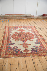 Classic layout of an antique Malayer rug with its central medallion and corner spandrels.