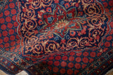 The textured wool pile of a vintage Kashan rug, with visible knot heads and foundation.