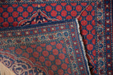 Corner view of a vintage Kashan mat, detailing the secure side cord and hand-knotted weave.
