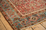 Antique Heriz rug corner with geometric Turtle Samovar designs on a dusty teal main border.