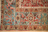 Antique Heriz rug corner with Turtle Samovar motifs in a dusty teal and rose border.