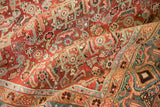 Textured low pile revealing intricate Herati and Turtle Samovar designs on a folded antique Heriz rug.