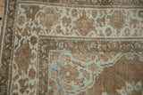 Antique Mahal carpet corner with time-softened powder blue palmettes and beige floral motifs.