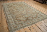 Detailed view of the antique distressed Mahal carpet, with time-softened powder blue and beige floral motifs.